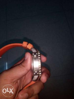 Round Silver Watch With Orange Rubber Strap