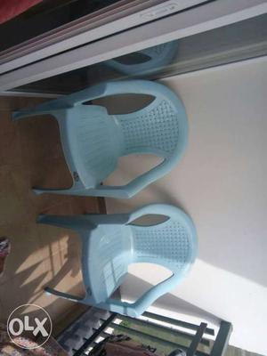 Two Teal Plastic Amrchairs