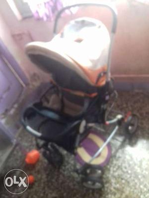 Baby's White, Black And Orange Stroller