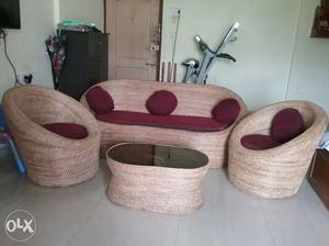 Cane sofa with two round chaires and center table.
