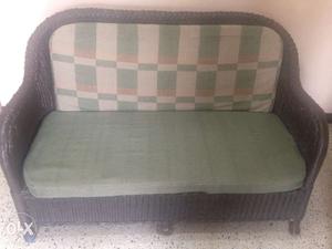 Good condition dark colour cane two seater sofa