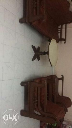Two Brown Wooden Armchairs,couch And White Pedestal Table