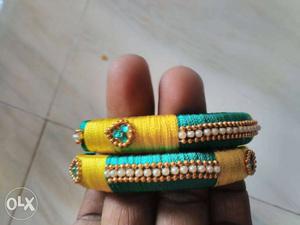 Two Yellow And Teal Silk Thread Bracelets