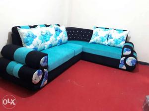 Blue And Teal Sectional Sofa With Floral Throw Pillows