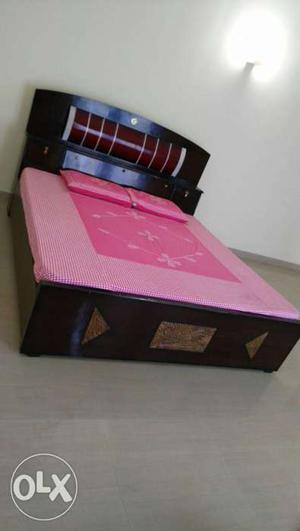 Brown Wooden Bed With Pink Mattress