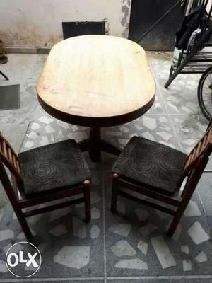 Oval Brown Wooden Table With Padded Chairs