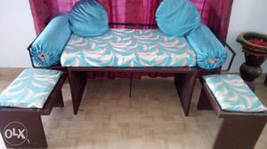 Small wooden sofa with cusions with 2 seaters.