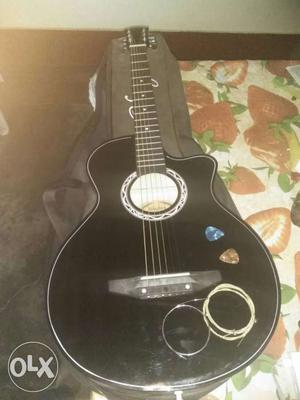 Black Cutaway Acoustic Guitar With Picks And Strings