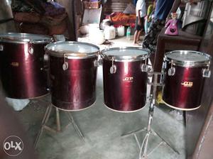 Four Maroon Percussion Instruments