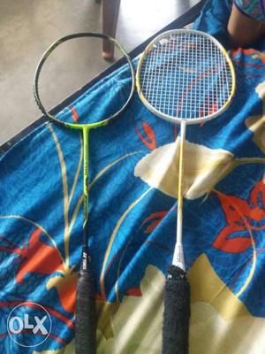 Two Green And Yellow Badminton Rackets
