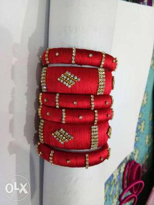 Six Red And Grey Embossed Silk Thread Bracelets