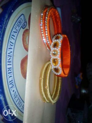 Three Orange And Brown Thread Bangle Bracelets