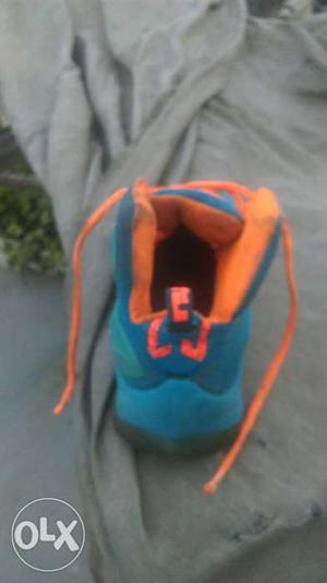 Unpaired Blue And Orange Basketball Shoe