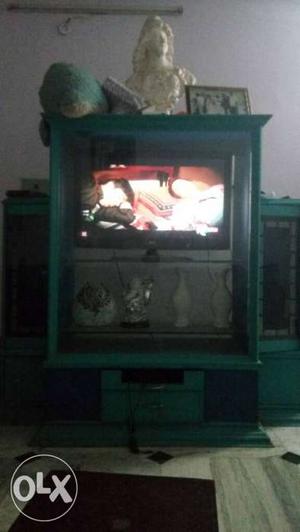 Gray RP TV On Teal Wooden TV Hutch