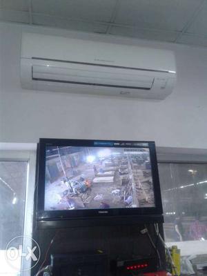 White Split Type Air Conditioner; Flat Screen Television