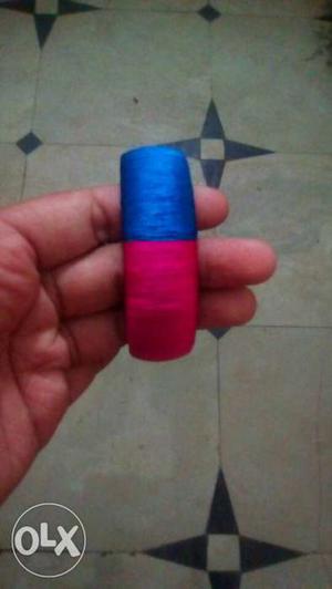 Cylindrical Blue And Red Thread Reel