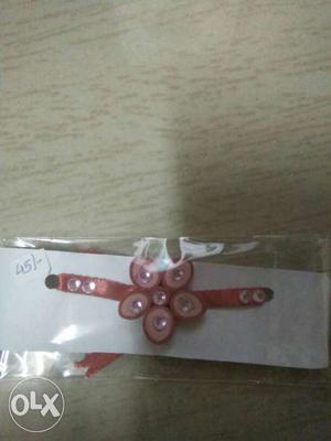 Red and pink coloured rakhi.