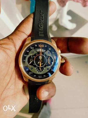 Round Gold Chronograph Watch With Black Rubber Band