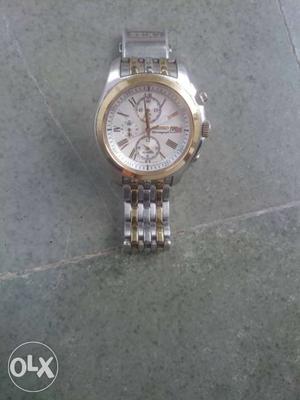Round Gold Frame Chronograph Watch With Silver Strap