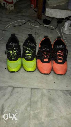 Two Pairs Of Green And Orange Basketball Shoes
