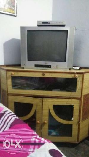 Grey CRT TV; Brown Wooden Cabinet Stand