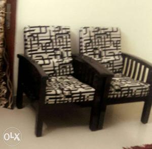Pair Of Black Wooden Framed Padded Armchairs