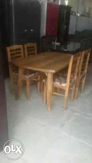 Rectangular Brown Wooden Table With Four Chairs