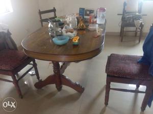 Wooden dining table with four chairs