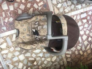 Baby's Beige And Brown Car Seat and Carrier