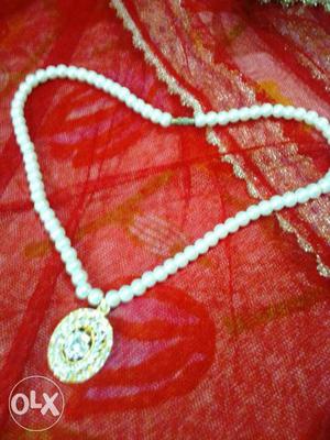 White Beaded Necklace With Round Gold Pendant