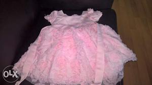12 months old girls pink rosette frock. Near to