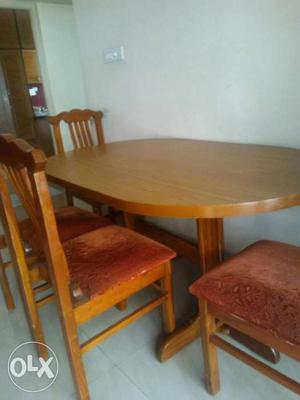 Brown Wooden Oval Top Table With four Chairs