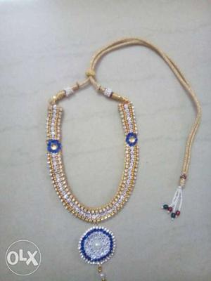 Brown, White, And Blue Necklace With Pendant