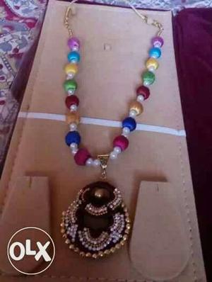 Gold, Red And Green Beaded Pendant Necklace