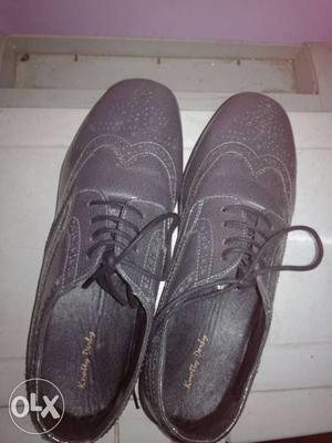Pair Of Black Leather Medallion Wingtip Derby Shoes