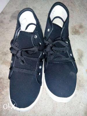 Pair Of White And Black Shoes