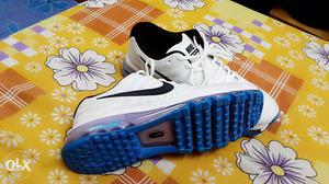 Pair Of White Nike Running Shoes