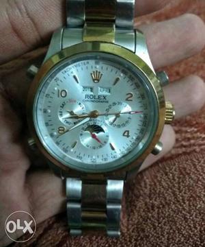 Round Silver And Gold Rolex Chronograph Watch With Silver