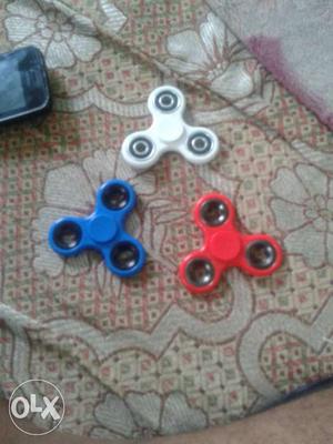 Three White, Blue, And Red Fidget Spinners