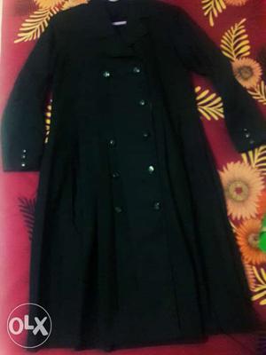 Black coat with pleats. Photo for reference.