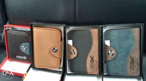 Four Brown, Blue And Green Leather Wallets In Boxes