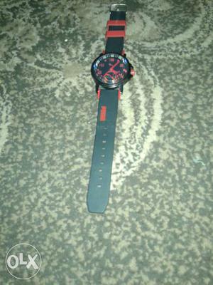 Puma Silver Round Face Watch With Black And Red Strap