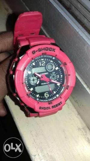 Round Black Casio G-Shock GA-100L4AER Watch With Red Rubber