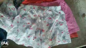 Three White, Pink, And Red Shorts