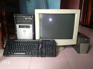 Beige CRT Computer Monitor; Black Computer Keyboard; Black