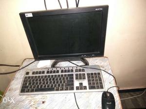 Flat Screen Computer Monitor With Gray Wired Keyboard And