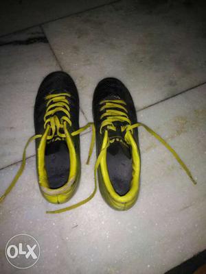 Pair Of Black And Yellow football Shoes