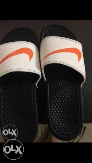 Pair Of White Nike Slide Sandals