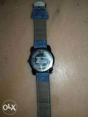 Round Faced Watch With Gray And Blue Leather Strap