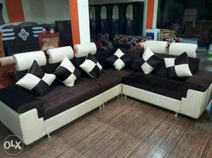 Brown, Black, And White Sectional Sofa With Six Throw